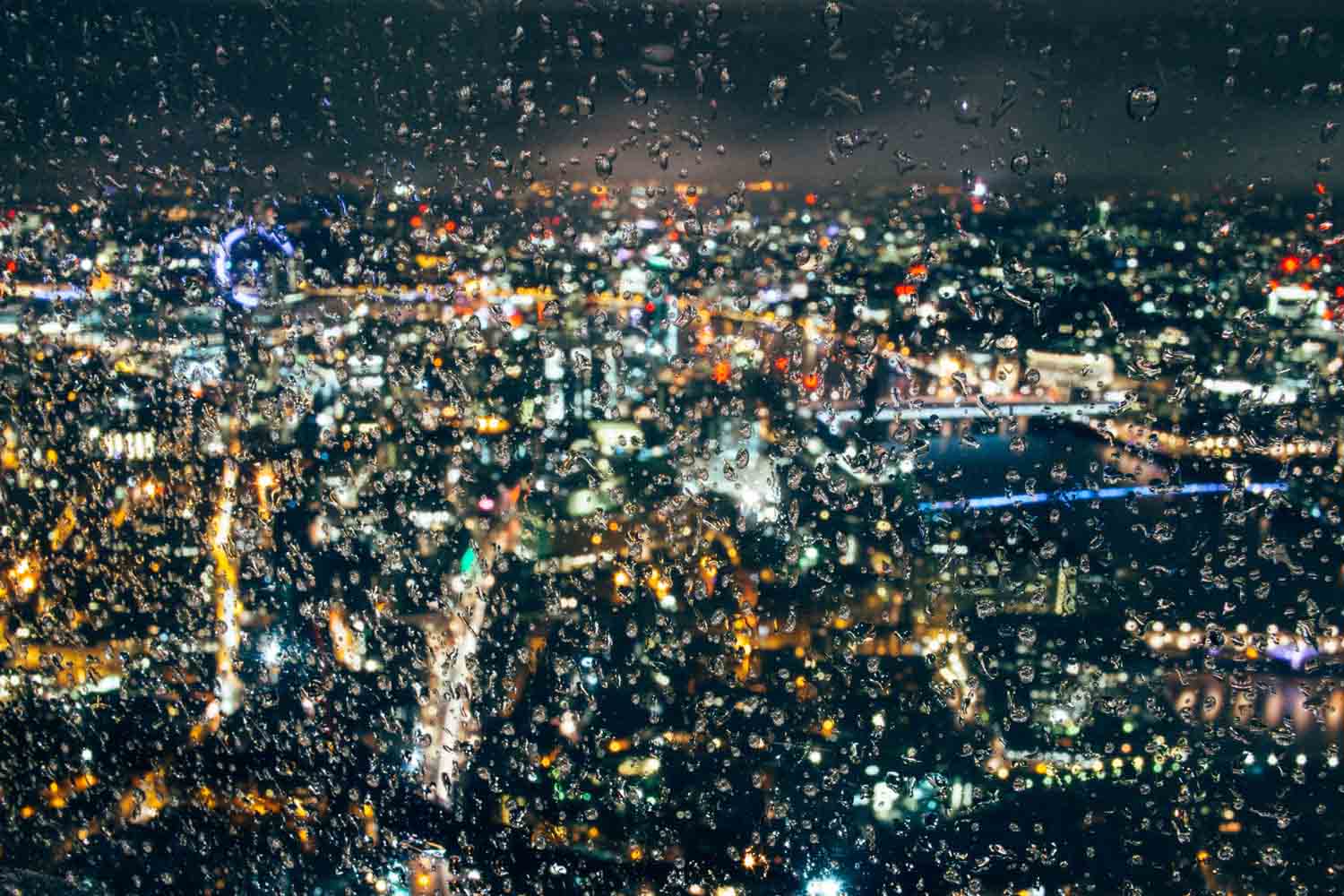 Rain covered window overlooking London